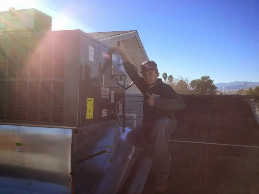 HVAC technician performing HVAC Inspection on a rooftop unit in Foothill Farms
